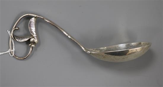 A 1920s Danish Georg Jensen sterling silver blossom pattern sauce ladle, no. 141, 17.2cm.